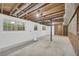 Unfinished basement space with visible ceiling joists and concrete floor at 2027 Kensington High Sw St, Lilburn, GA 30047