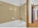 Bathroom featuring a bathtub with neutral-tone tile surround at 2027 Kensington High Sw St, Lilburn, GA 30047
