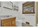 Bathroom featuring a single sink vanity and toilet at 2027 Kensington High Sw St, Lilburn, GA 30047