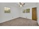 This carpeted bedroom is brightened by two windows and features a ceiling fan at 2027 Kensington High Sw St, Lilburn, GA 30047