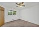The bright carpeted bedroom has a ceiling fan and large window at 2027 Kensington High Sw St, Lilburn, GA 30047