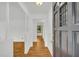 Bright entryway with hardwood floors, white walls, and decorative spindle columns at 2027 Kensington High Sw St, Lilburn, GA 30047