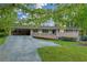 Charming brick home with a covered carport and a welcoming front porch at 2027 Kensington High Sw St, Lilburn, GA 30047