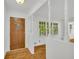 Welcoming foyer featuring hardwood floors, fresh paint, and natural light at 2027 Kensington High Sw St, Lilburn, GA 30047