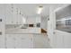 Bright, white kitchen with tile floors, stainless appliances and wood accents at 2027 Kensington High Sw St, Lilburn, GA 30047