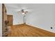 Spacious living room features a ceiling fan, hardwood floors, and brick fireplace at 2027 Kensington High Sw St, Lilburn, GA 30047