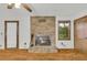 Inviting living room with brick fireplace, wood-look floors, and bright natural light at 2027 Kensington High Sw St, Lilburn, GA 30047