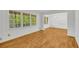 Bright living room with hardwood floors, large windows, and an adjacent dining area at 2027 Kensington High Sw St, Lilburn, GA 30047