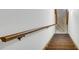 Basement access with wood staircase and wood banister at 2027 Kensington High Sw St, Lilburn, GA 30047