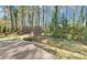 Scenic backyard with a cozy fire pit, complemented by lush greenery and mature trees at 2195 Brickton Sta, Buford, GA 30518
