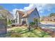 This backyard features a lush green lawn, mature trees, and a back deck off the rear of this two-story home at 2195 Brickton Sta, Buford, GA 30518