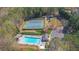 Aerial shot featuring community pool and tennis courts surrounded by lush trees at 2195 Brickton Sta, Buford, GA 30518
