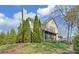 Charming home featuring a stone chimney and a well-maintained, green sloping lawn at 2195 Brickton Sta, Buford, GA 30518