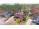 An aerial view highlights a well-manicured lawn and landscaped front yard of a stately two-story brick home at 2195 Brickton Sta, Buford, GA 30518