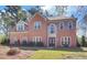 Classic brick home with a manicured lawn and traditional double-door entrance at 2195 Brickton Sta, Buford, GA 30518