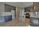 Stylish kitchen featuring dark cabinetry, light countertops, stainless appliances, and wood-look floors at 2195 Brickton Sta, Buford, GA 30518