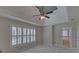 This main bedroom boasts a tray ceiling with a fan, lots of natural light and a door to the ensuite bathroom at 2195 Brickton Sta, Buford, GA 30518