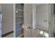 Walk-through pantry with multiple shelves leading to laundry room with washer dryer hookups and shelving at 2195 Brickton Sta, Buford, GA 30518