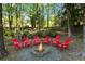 Backyard fire pit with inviting red Adirondack chairs, perfect for cozy evenings and gathering with friends at 2801 Livsey Dr, Tucker, GA 30084