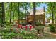Beautifully landscaped backyard with mature trees, firepit area, hammock and playhouse at 2801 Livsey Dr, Tucker, GA 30084
