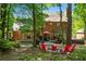 Spacious brick home featuring a back patio, hammock, firepit and lush landscaping at 2801 Livsey Dr, Tucker, GA 30084