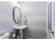 Powder room features horizontal stripes, a pedestal sink, and a decorative mirror at 2801 Livsey Dr, Tucker, GA 30084