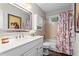 Bathroom featuring a single sink vanity with a large mirror and a bathtub with a shower at 2801 Livsey Dr, Tucker, GA 30084