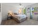 Cozy bedroom features a patterned bedspread, neutral walls, and ample natural light from the window at 2801 Livsey Dr, Tucker, GA 30084