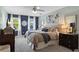 Spacious bedroom with plush carpet, ceiling fan, and large window with stylish sheer curtains at 2801 Livsey Dr, Tucker, GA 30084