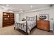 Comfortable bedroom with a charming vintage bed, dark wood bookcase and dresser creating a serene retreat at 2801 Livsey Dr, Tucker, GA 30084