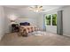 Bright bedroom featuring a colorful quilt, a large window, and soft natural light at 2801 Livsey Dr, Tucker, GA 30084