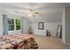 Bright bedroom with a large window, neutral walls, and a ceiling fan provides a serene atmosphere at 2801 Livsey Dr, Tucker, GA 30084