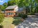 Traditional brick home with well-manicured lawn, mature trees, and spacious driveway at 2801 Livsey Dr, Tucker, GA 30084