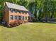 Classic brick home with lush front lawn, vibrant flower bushes and mature trees at 2801 Livsey Dr, Tucker, GA 30084