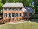 Charming brick two-story home with a well-manicured lawn and blooming flower beds at 2801 Livsey Dr, Tucker, GA 30084