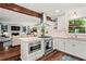 Open kitchen boasts stainless appliances, wood floors, granite countertops, and a view into the living room at 2801 Livsey Dr, Tucker, GA 30084