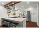 Bright kitchen features a wooden beam, granite countertops, stainless steel appliances, and an island with seating at 2801 Livsey Dr, Tucker, GA 30084