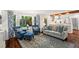 Bright living room with large windows, sofa and a view into the kitchen at 2801 Livsey Dr, Tucker, GA 30084