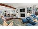 Open-concept living room with a fireplace, connecting dining area, and hardwood floors at 2801 Livsey Dr, Tucker, GA 30084
