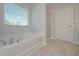 This bathroom features a large soaking tub and shower with modern fixtures at 484 Charleston Pl, Villa Rica, GA 30180