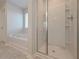This bathroom features a large soaking tub, shower, and modern fixtures at 484 Charleston Pl, Villa Rica, GA 30180