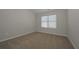 Cozy bedroom with neutral walls and a window offering natural light at 484 Charleston Pl, Villa Rica, GA 30180