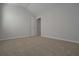 This bedroom has neutral walls and carpet flooring, and an open closet at 484 Charleston Pl, Villa Rica, GA 30180