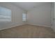 Bedroom features plush carpeting and natural light from dual windows at 484 Charleston Pl, Villa Rica, GA 30180