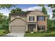 Charming two-story home featuring a mix of brick and siding with a covered front porch and attached two-car garage at 484 Charleston Pl, Villa Rica, GA 30180