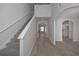 Bright foyer boasts beautiful wood floors, a staircase and open arches to other rooms at 484 Charleston Pl, Villa Rica, GA 30180