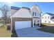 Charming two-story home with attached garage and well-manicured front lawn at 484 Charleston Pl, Villa Rica, GA 30180