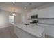 Kitchen featuring a granite island, stainless steel appliances, subway tile backsplash, and wood floors at 484 Charleston Pl, Villa Rica, GA 30180