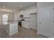 Modern kitchen with white cabinets, granite countertops, stainless appliances, and wood floors at 484 Charleston Pl, Villa Rica, GA 30180