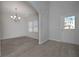Bright living room featuring sleek wood floors, a modern chandelier and a door to the outside at 484 Charleston Pl, Villa Rica, GA 30180